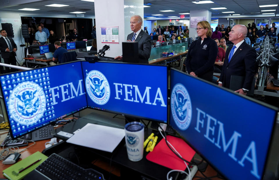 U.S. President Joe Biden is flanked by Federal Emergency Management Agency (FEMA) Administrator Deanne Criswell and Department of Homeland Security (DHS) Secretary Alejandro Mayorkas as he delivers remarks inside Federal Emergency Management Agency (FEMA) headquarters, where he received a briefing on the impact of Hurricane Ian, in Washington, U.S., September 29, 2022. REUTERS/Kevin Lamarque