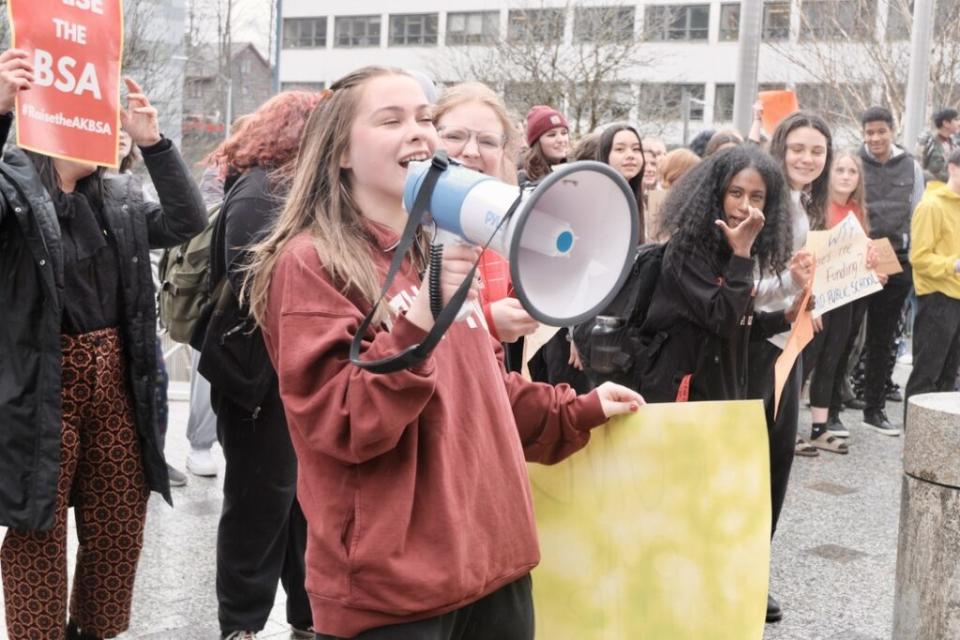 Rachel Wood, a Juneau-Douglas High School student, challenges the state legislators who voted to uphold Gov. Mike Dunleavy's education funding veto, to come out of their offices at the Capitol and explain themselves on April 4, 2024. (Photo by Claire Stremple/Alaska Beacon)