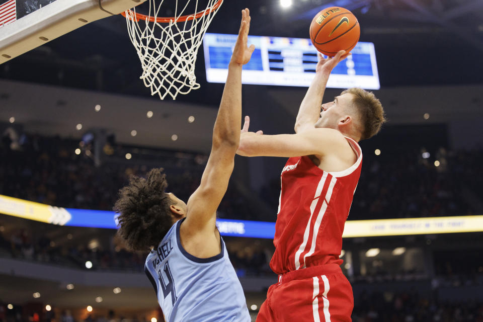 Dec 3, 2022; Milwaukee, Wisconsin, USA; Wisconsin Badgers forward Tyler Wahl (5) shoots over Marquette Golden Eagles guard Stevie Mitchell (4) during the first half at Fiserv Forum. Mandatory Credit: Jeff Hanisch-USA TODAY Sports