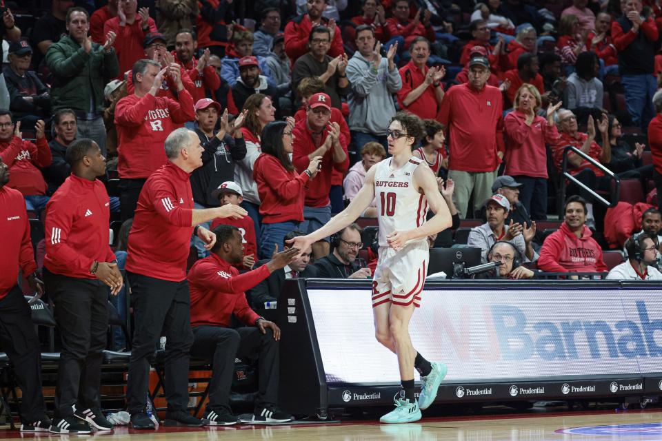 Nov 10, 2023; Piscataway, New Jersey, USA; Rutgers Scarlet Knights guard Gavin Griffiths (10) slaps hands with coaches after being subbed out the game during the second half against the Boston University Terriers at Jersey Mike's Arena. Mandatory Credit: Vincent Carchietta-USA TODAY Sports