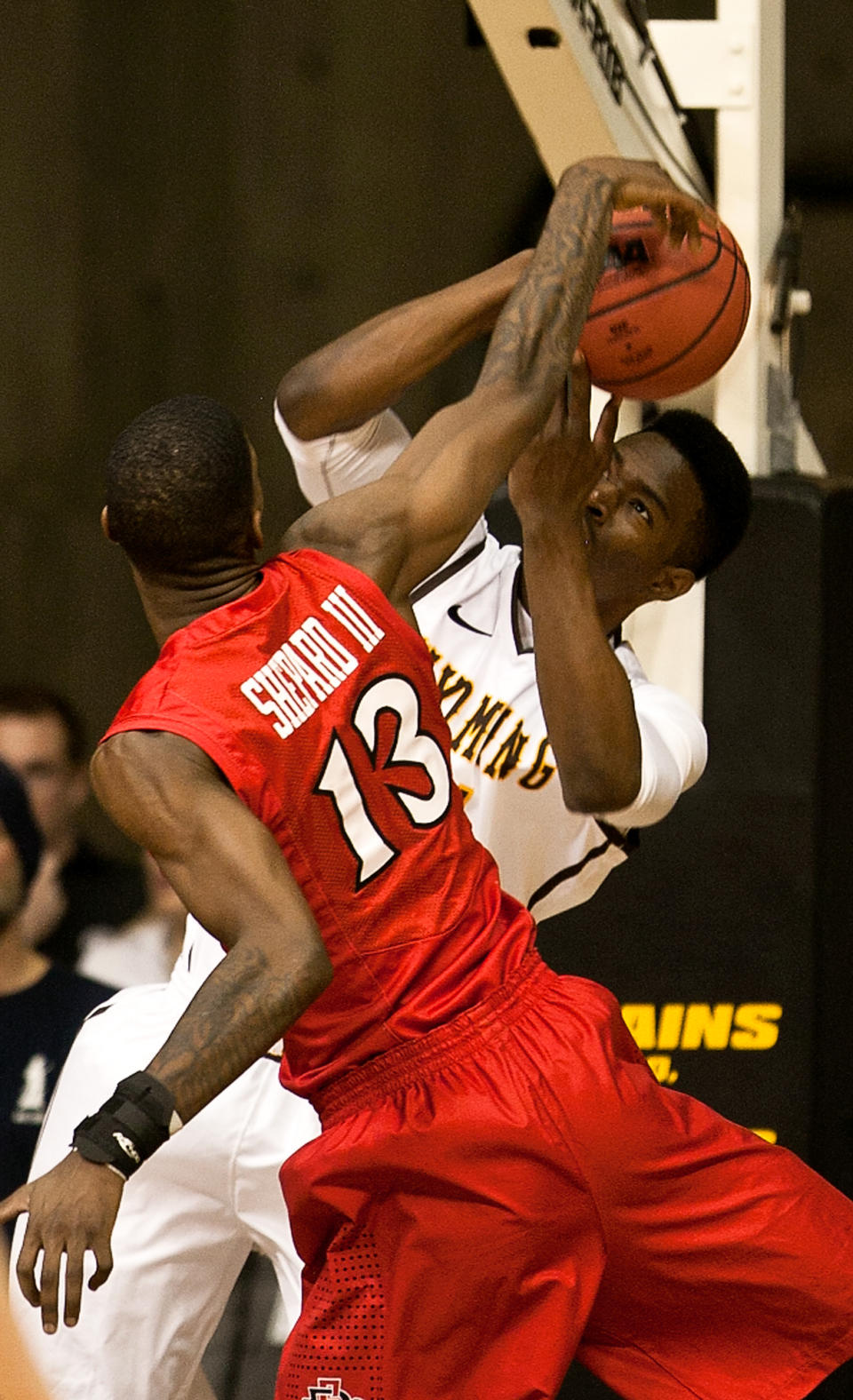 San Diego State forward Winston Shepard (13) blocks a shot by University of Wyoming Cowboys forward Dereck Cooke Jr. (11) in a NCAA college basketball game Tuesday, Feb. 11, 2014 at the Arena-Auditorium in Laramie, Wyo. (AP Photo/Jeremy Martin)