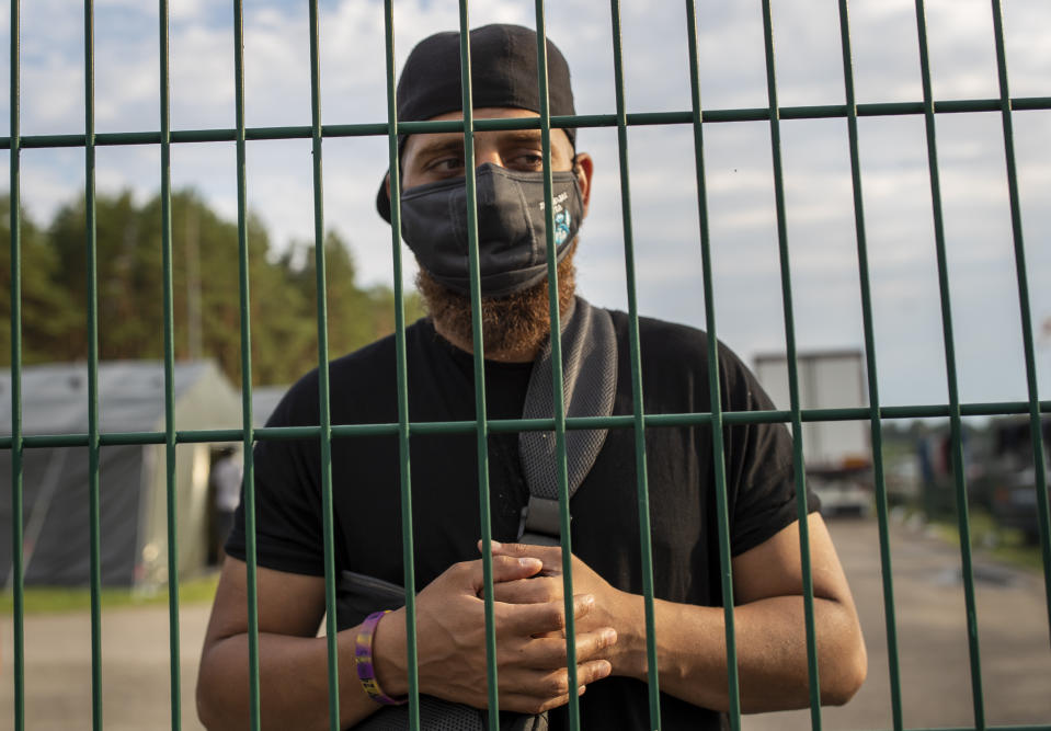 Aly, surname unknown, a migrant from Baghdad, Iraq, speaks to the Associated Press journalists at a refugee camp outside Druskininkai, Lithuania, Tuesday, July 13, 2021. Lithuania has struggled with a flow of migrants from the Middle East and Africa — a huge influx that officials in the tiny Baltic country say was organized by Belarusian authorities as part of a "hybrid war" against the European Union. (AP Photo/Mindaugas Kulbis)