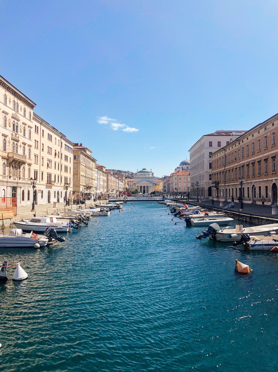 Port city of Trieste's downtown area with boats lining the marina.