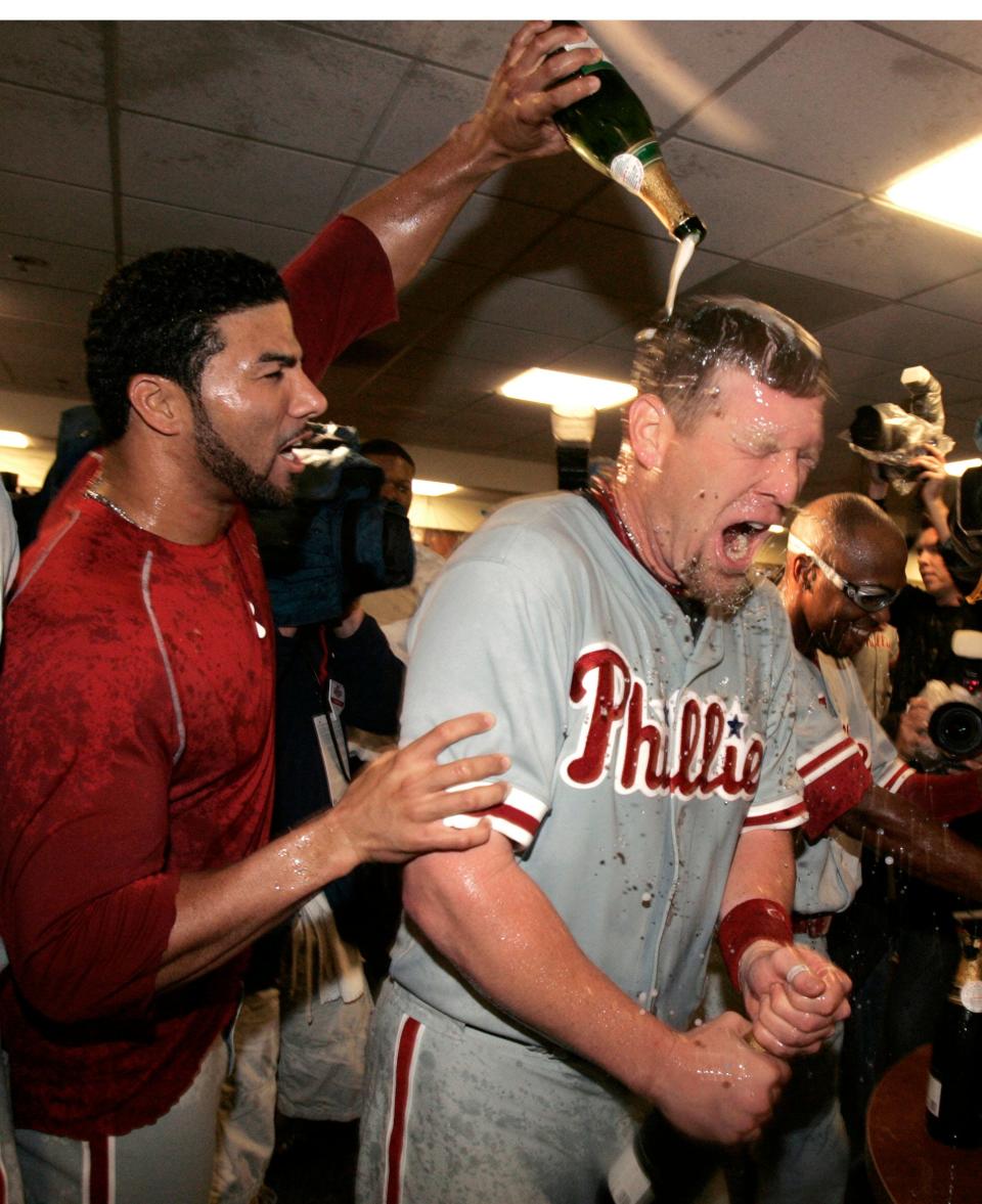 Former Milwaukee Brewers player Geoff Jenkins is showered in champagne by teammate Pedro Feliz after the Phillies beat the Milwaukee Brewers, 6-2, to clinch the National League Division Series at Miller Park, Sunday, October 6, 2008.