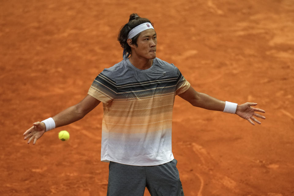 Zhang Zhizhen of China celebrates his victory over Taylor Fritz, of the United States, at the Madrid Open tennis tournament in Madrid, Spain, Tuesday, May 2, 2023. (AP Photo/Manu Fernandez)
