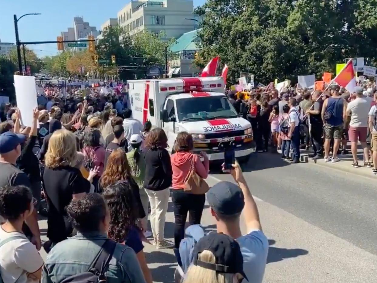 An ambulance carrying a patient in critical condition in Vancouver was delayed as demonstrators protesting Covid-19 regulations  (Twitter / Lasia Kretzel)