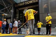 People paint "Black Lives Matter" along 5th avenue outside Trump Tower in New York City