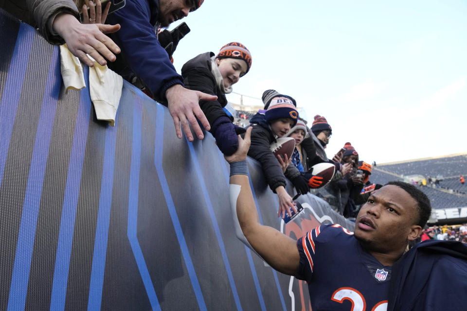 Chicago Bears running back David Montgomery, right, leaves the field after an NFL football game against the Minnesota Vikings, Sunday, Jan. 8, 2023, in Chicago. The Vikings won 29-13. (AP Photo/Nam Y. Huh)