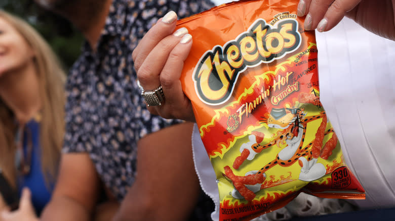 Person holding Cheetos bag