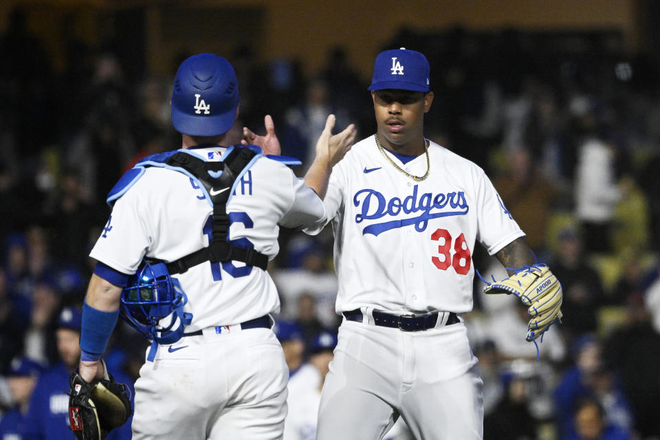 Los Angeles Dodgers catcher Will Smith, left, and relief pitcher Yency Almonte congratulated each other after the Dodgers defeated the Arizona Diamondbacks 8-2 in an opening day baseball game Thursday, March 30, 2023, in Los Angeles. (AP Photo/Mark J. Terrill)