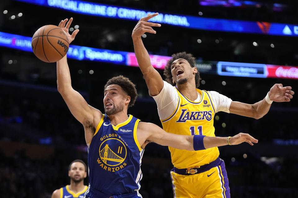 Golden State Warriors guard Klay Thompson, left, and Los Angeles Lakers center Jaxson Hayes reach for a rebound during the first half of an NBA preseason basketball game Friday, Oct. 13, 2023, in Los Angeles. (AP Photo/Mark J. Terrill)