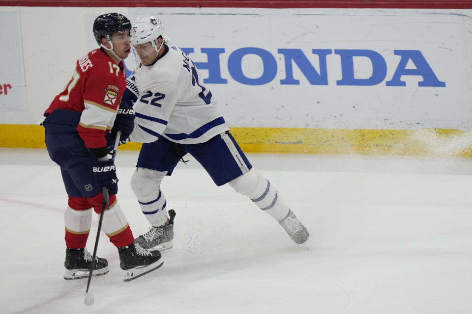 Toronto Maple Leafs defenseman Jake McCabe (22) slashes Florida Panthers center Evan Rodrigues (17) during the first period of an NHL hockey game, Tuesday, April 16, 2024, in Sunrise, Fla. (AP Photo/Wilfredo Lee)