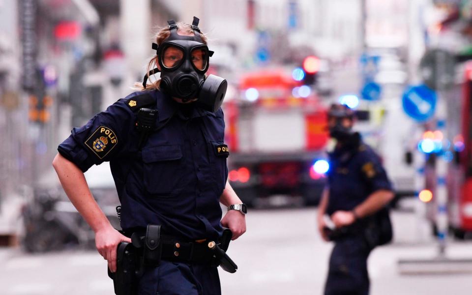 Police officers at the scene of the Stockholm attack - Credit: JONATHAN NACKSTRAND/AFP