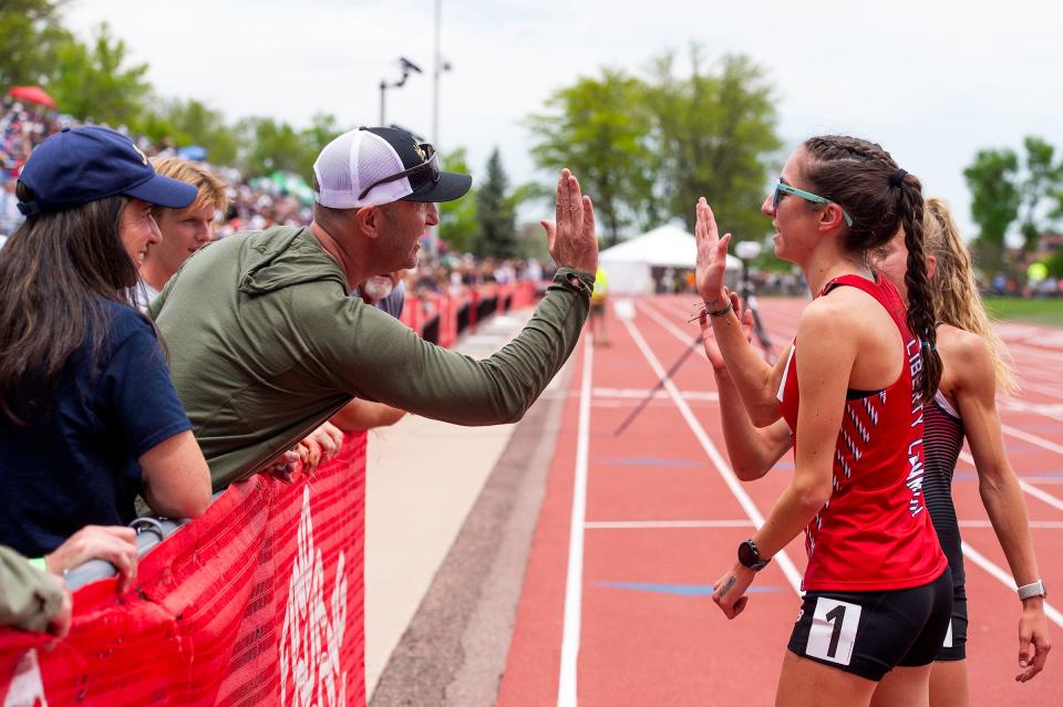 Liberty Common's Isabel Allori gets a high five after placing first and setting a state record in the 3A girls 1600 during the Colorado track & field state championships on Saturday, May 17, 2024 at Jeffco Stadium in Lakewood, Colo.