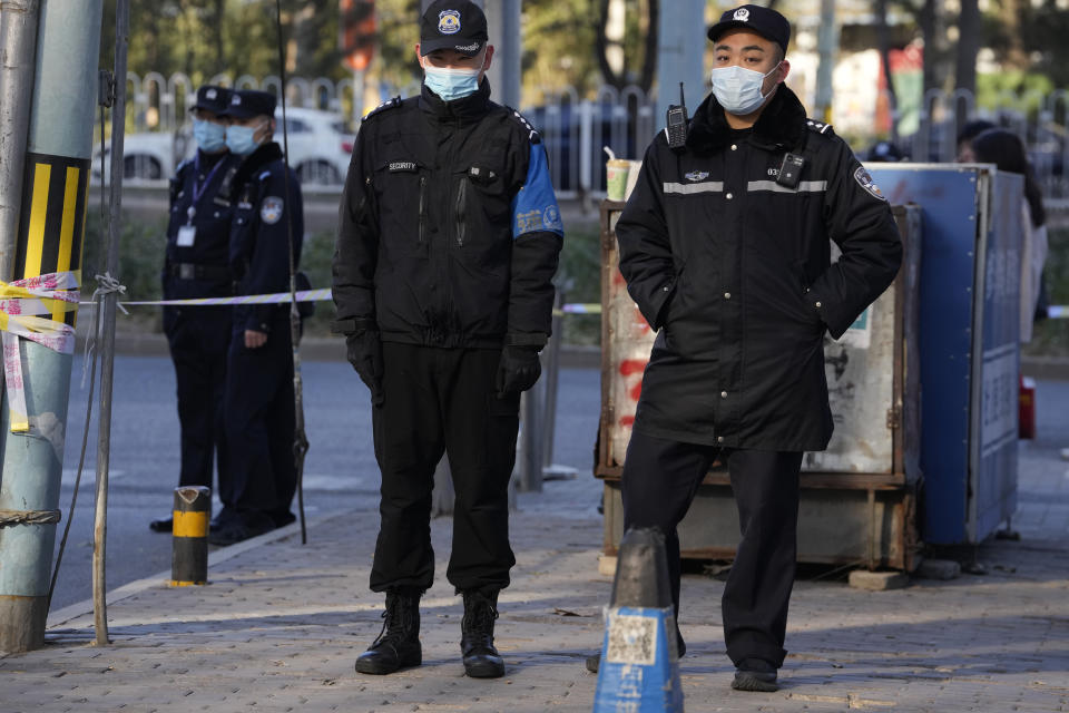 Chinese police officers cordon off an area near the Chaoyang district court where compensations hearings are held for relatives of passengers on the missing Malaysian Airline MH370 in Beijing, Monday, Nov. 27, 2023. A Beijing court is holding compensation hearings for Chinese relatives of people who died on a Malaysia Airlines plane that disappeared in 2014 on a flight to Beijing. (AP Photo/Ng Han Guan)