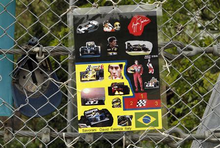 Pictures of Formula One Brazilian driver Ayrton Senna are seen on a fence at the site where Senna died at the race track in Imola April 22, 2014. REUTERS/Alessandro Garofalo
