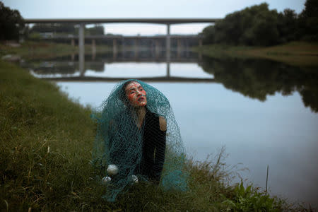 Chinese performance artist Han Bing poses for German photographer Katharina Hesse during a shoot at the outskirts of Beijing, China, October 2, 2017. REUTERS/Thomas Peter