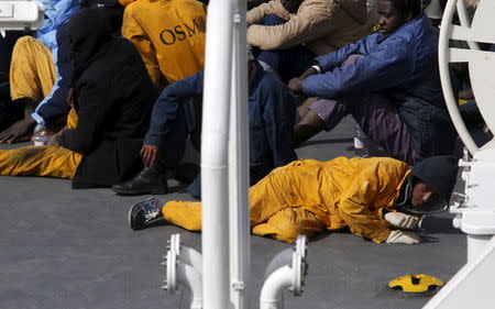 Surviving immigrants lie on the deck of Italian coastguard ship Bruno Gregoretti in Senglea, in Valletta's Grand Harbour April 20, 2015. REUTERS/Darrin Zammit Lupi