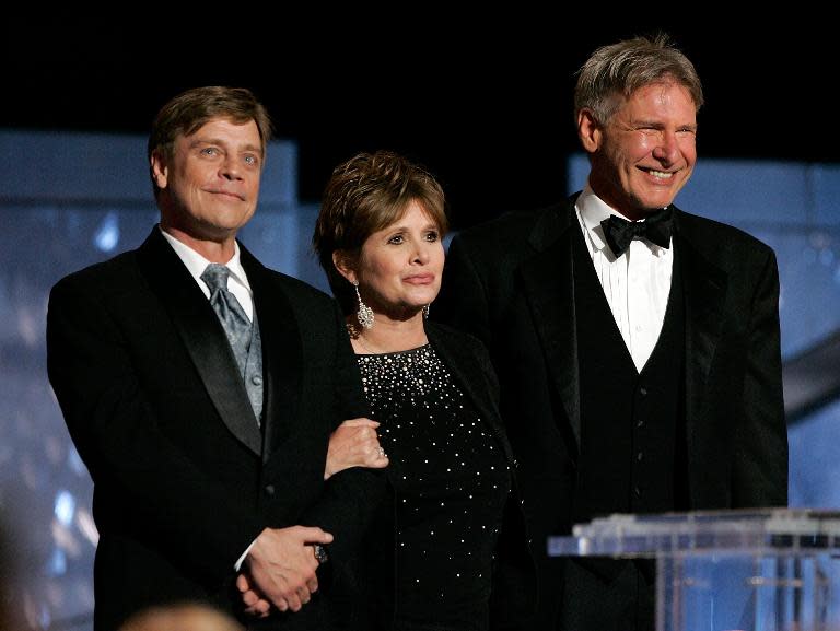 L-R: Actors Mark Hamill, Carrie Fisher and Harrison Ford speak during an tribute to George Lucas at the Kodak Theatre on June 9, 2005 in Hollywood, California