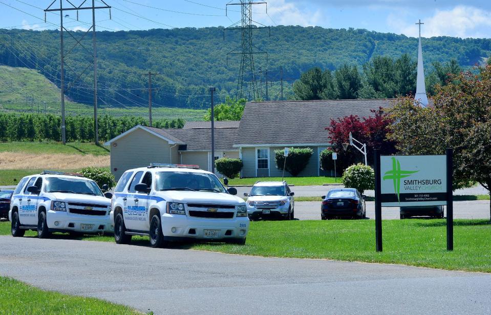 Washington County Sheriff's Office vehicles are parked outside Smithsburg Valley Church on Bickle Road Friday. The church is near Columbia   Machine, which had been the scene of a mass shooting on Thursday.