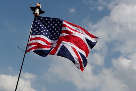 A Trump supporter holds a flag near the U.S. Embassy, ahead of a rally during the visit of U.S. President Donald Trump to Britain, in London