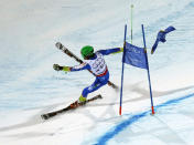 Misel Zerak of Slovenia crashes after a gate flag flies away from his face after skiing through it during the national team event at the World Alpine Skiing Championships in Schladming February 12, 2013. REUTERS/Leonhard Foeger (AUSTRIA - Tags: SPORT SKIING) - RTR3DOWR