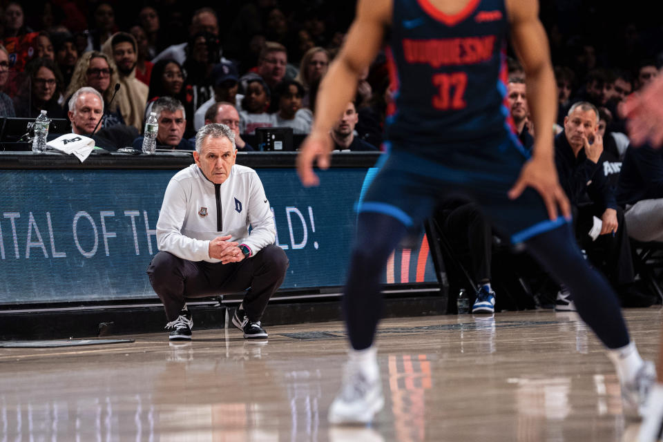 Duquesne head coach Keith Dambrot, left, watches his team during the first half of an NCAA college basketball game against VCU in the championship of the Atlantic 10 Conference tournament on Sunday, March 17, 2024, in New York. (AP Photo/Peter K. Afriyie)