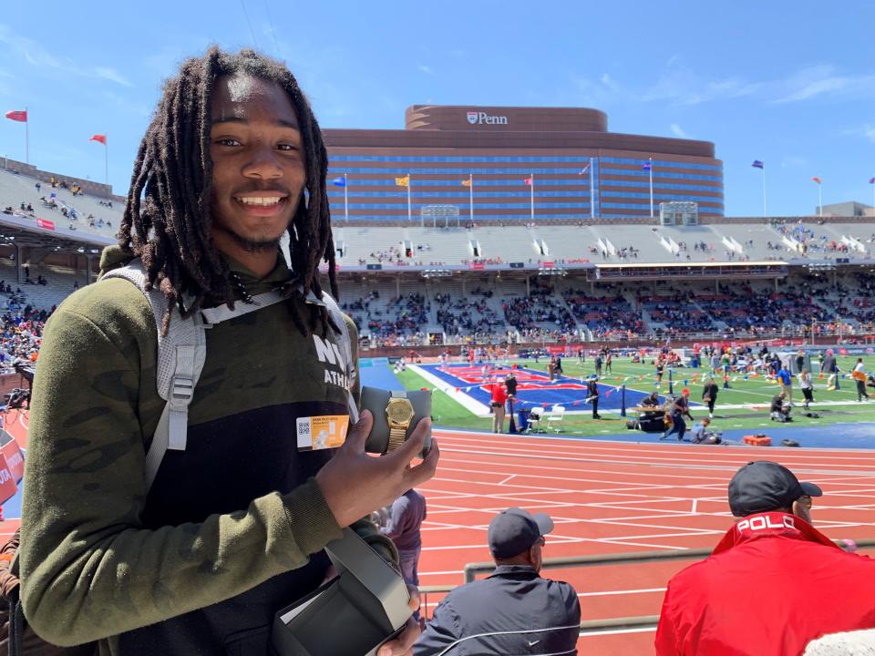 South Brunswick's Damarion Potts holds up his Penn Relays watch after placing second as the top American in the boys high jump