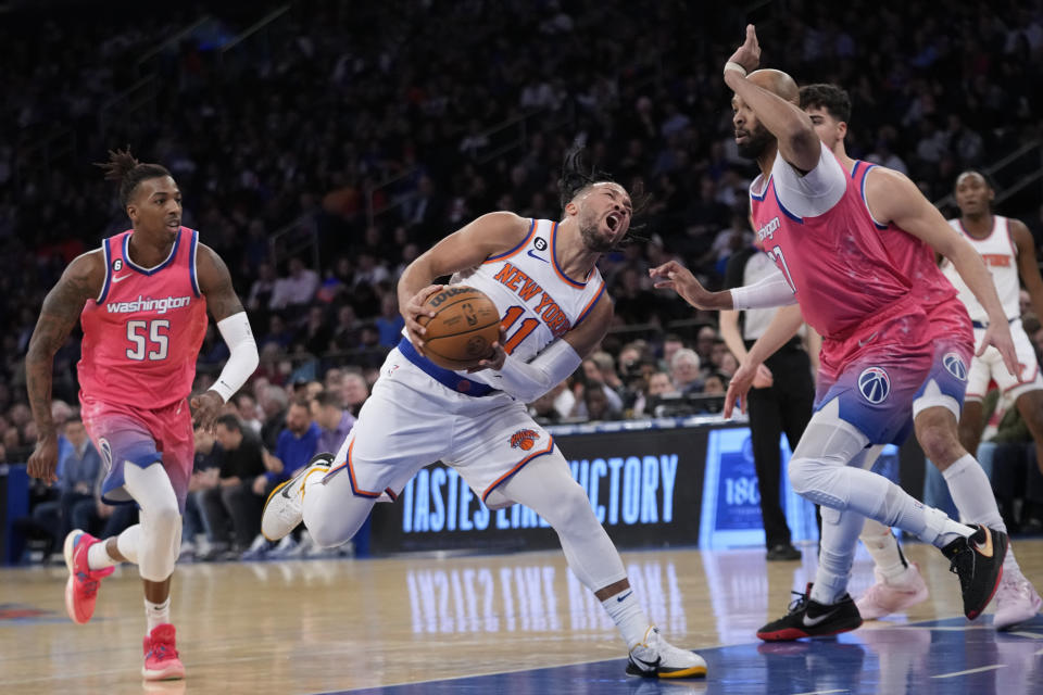 New York Knicks guard Jalen Brunson (11) drives against Washington Wizards forward Taj Gibson, right, and guard Delon Wright (55) during the first half of an NBA basketball game Wednesday, Jan. 18, 2023, at Madison Square Garden in New York. (AP Photo/Mary Altaffer)