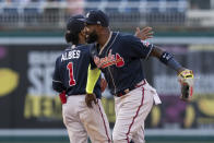 Atlanta Braves left fielder Marcell Ozuna (20) and second baseman Ozzie Albies (1) celebrate after winning a baseball game against the Washington Nationals in Washington, Thursday, May 6, 2021. (AP Photo/Manuel Balce Ceneta)