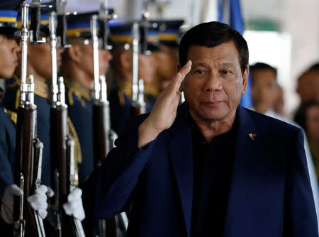 Philippine President Rodrigo Duterte salutes the honor guards upon arrival from Russia at the Ninoy Aquino International airport in Paranaque, Metro Manila, Philippines May 24, 2017. REUTERS/Erik De Castro
