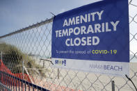 A sign is posted at a closed entrance to the beach during the new coronavirus pandemic, Friday, July 3, 2020, in the South Beach neighborhood of Miami Beach, Fla. Beaches throughout South Florida are closed for the busy Fourth of July weekend to avoid further spread of the new coronavirus. (AP Photo/Lynne Sladky)