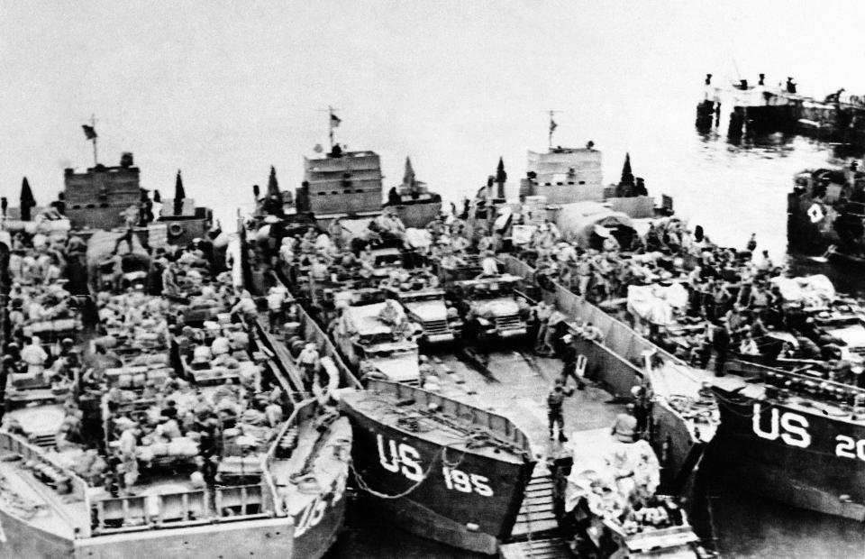 Landing craft loaded with invasion assault landing craft tanks are loaded with half tracks and other armored vehicles by American troops at an embarkation point in England on June 6, 1944, just before they set sail for the D-Day invasion of the French coast. (Photo: AP)