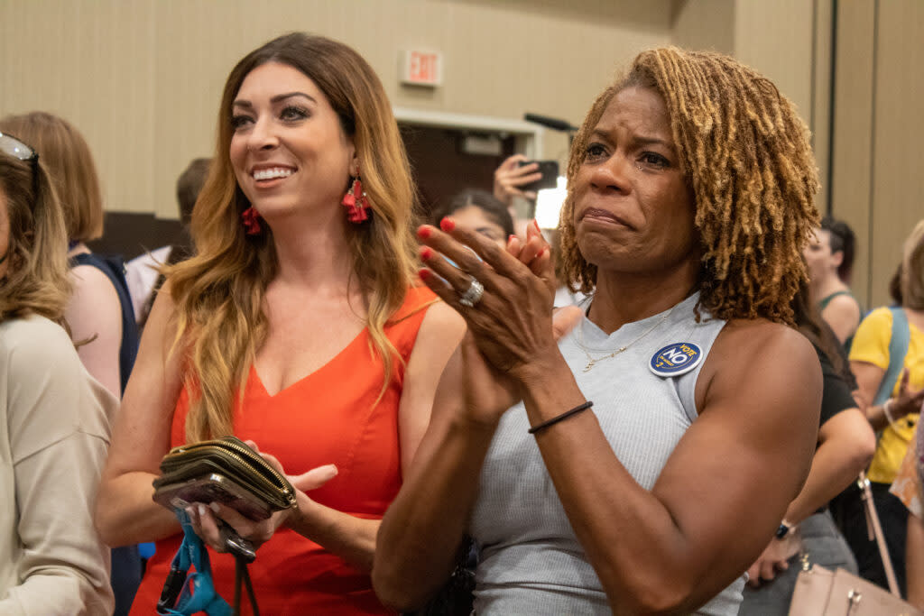 Dawn Rattan, right, cries and applauds Aug. 2, 2022, at the Kansans for Constitutional Freedom watch party after learning Kansans had defeated a constitutional amendment to remove abortion rights. (Lily O'Shea Becker/Kansas Reflector)