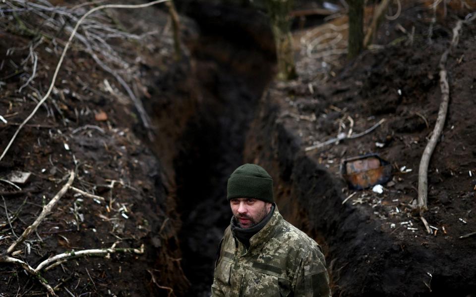 A Ukrainian serviceman of a fire platoon stands in a trench near the frontline - LISI NIESNER/REUTERS