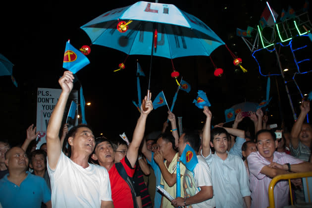 Supporters wave flags and umbrellas, alongside a home-made LED-lit contraption that flashed the message "WP", "VOTE" and "LLL" in succession. (Yahoo! photo)