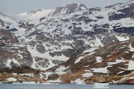 An abandoned house stands on the shore of a fjord near Tasiilaq, Greenland, June 16, 2018. REUTERS/Lucas Jackson