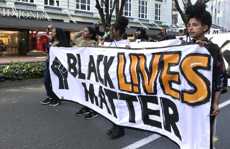 Protesters chant during a Black Lives Matter protest in central Wellington, New Zealand, Sunday June, 14, 2020. Thousands of New Zealanders turned out to protests Sunday in Auckland and Wellington. In Auckland, the protest began at the central Aotea Square and ended at the U.S. consulate, where protesters took a knee and observed a minute's silence to commemorate George Floyd, who died at the hands of Minneapolis police last month. (Jason Walls/NZME via AP)