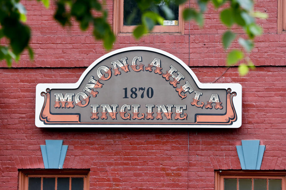 A sign marks the lower terminal of the Monongahela Incline on Friday, May 10, 2019, in Pittsburgh. The incline that transports people up and down the side of a hill in Pittsburgh reopened Friday after being closed since February. (AP Photo/Keith Srakocic)