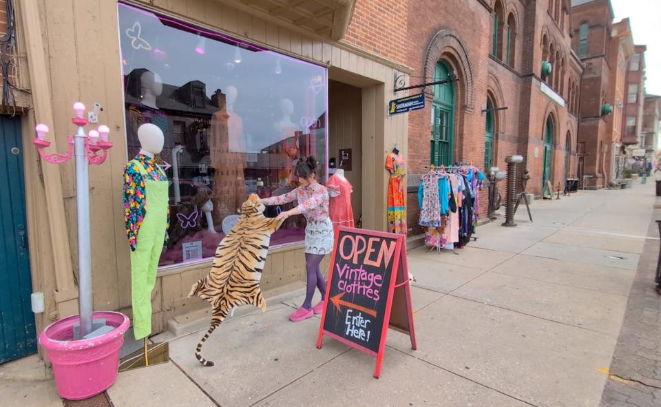 Ariel Linebaugh sets out goods in front of Feral Heart Club in the first block of North Beaver Street in York