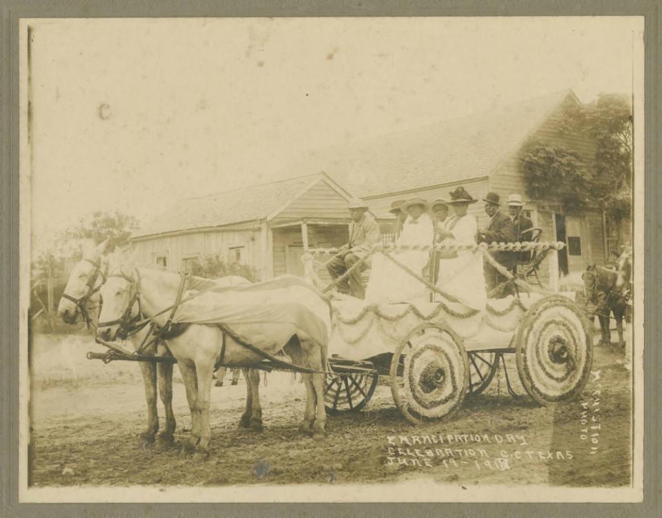 A group of people ride a decorated horse-drawn carriage to celebrate Juneteenth.