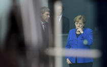 German Chancellor Angela Merkel waits for the arrival of guest at the chancellery ahead of a conference on Libya in Berlin, Germany, Sunday, Jan. 19, 2020. German Chancellor Angela Merkel hosts the one-day conference of world powers on Sunday in Berlin to discuss efforts to broker peace in Libya. (AP Photo/Jens Meyer)