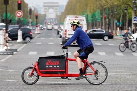 A cycling courier delivers goods for Eagles, as part of the emergence for what is known as the 'gig economy', in Paris, France, April 4, 2017. Picture taken April 4, 2017. REUTERS/Charles Platiau