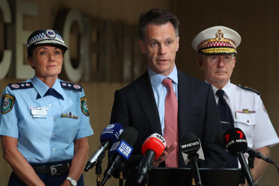 Premier of New South Wales Chris Minns (C), NSW Police Commissioner Karen Webb (L) and Ambulance Commissioner Dominic Morgan speak during a press conference on April 16, 2024 in Sydney, Australia. Hundreds clashed with police in western Sydney after an Orthodox Christian bishop was allegedly stabbed at the alter at Mar Mari Emmanuel at Assyrian church in Wakeley.