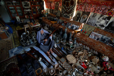 Youssef Akkar, 80, an Iraqi retired teacher holds an old weapon in his museum at home in Najaf, Iraq February 21, 2019. REUTERS/ Alaa al-Marjani