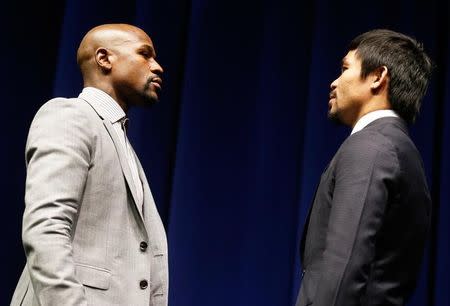 Eleven-time, five-division world boxing champion Floyd "Money" Mayweather (L) and eight-division world champion Manny "Pac-Man" Pacquiao attend a press conference in Los Angeles, California March 11, 2015. REUTERS/Lucy Nicholson