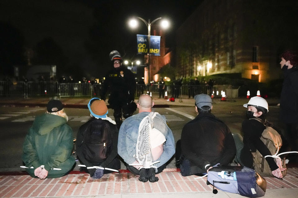 Demonstrators arrested on UCLA campus in the early hours of Thursday morning. (Ryan Sun / AP)