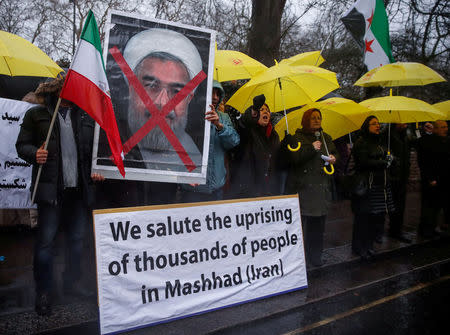 FILE PHOTO: Opponents of Iranian President Hassan Rouhani hold a protest outside the Iranian embassy in west London, December 31, 2017. REUTERS/Eddie Keogh/File Photo