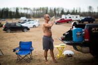 Mike Graham takes a sip of water as he prepares his lunch on Indian Beach just south of Fort McMurray May 4, 2016. REUTERS/Topher Seguin