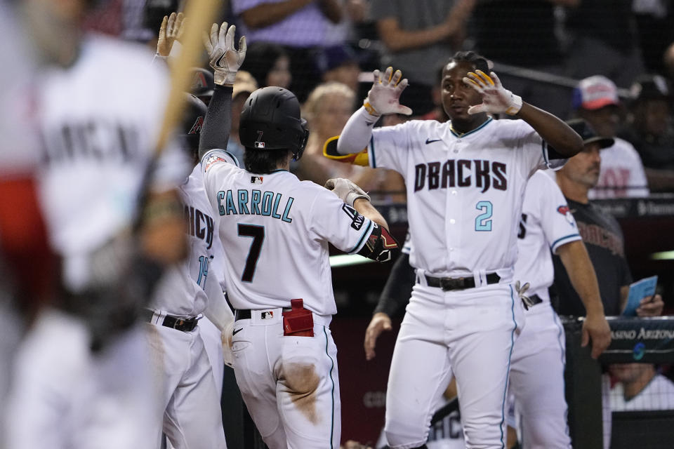 Arizona Diamondbacks' Corbin Carroll (7) celebrates after hitting a two run home run against the Cincinnati Reds during the eighth inning of a baseball game, Thursday, Aug. 24, 2023, in Phoenix. (AP Photo/Matt York)